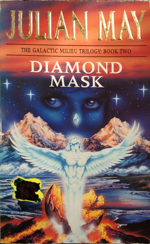 Cover of Diamond Mask by Julian May. A silvery man with wings bursts from an egg cracked over lava. Behind him are two ice mountains. The starry sky in space is behind it with the image of a woman's face imposed over the sky.