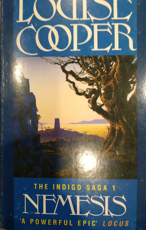 Cover of Nemesis by Louise Cooper. Book one in the Indigo Saga. The text is before a azure blue background with a painting between them. A gnarled tree is in the foreground beside some darkened ruins, with a sunset moving over hills in the background.